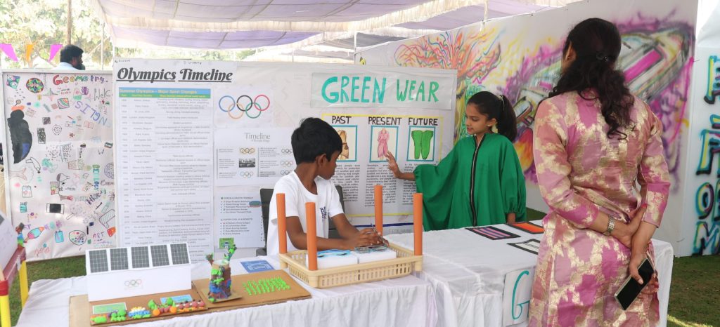 A student showcasing their project-based learning Montessori explore event 2025. 