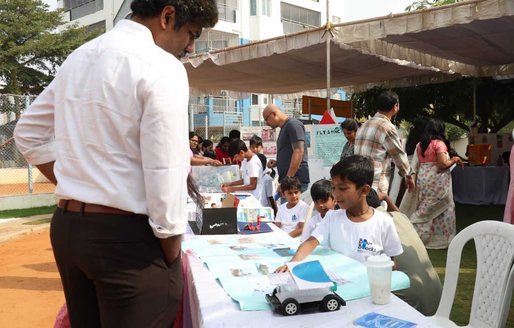 Self-expression in Montessori in practice — a young child explaining a project to visitors at Blue Blocks Montessori School in Hyderabad.