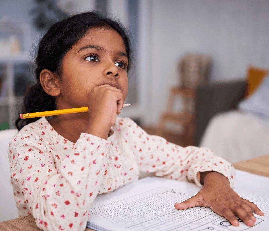 A child pausing to think before answering, teaching children to think at Blue Blocks Montessori School, Hyderabad.