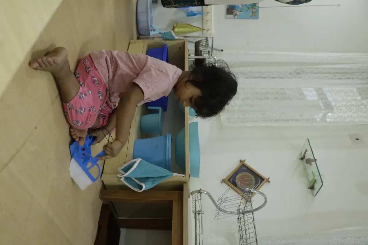 Child sweeping the floor