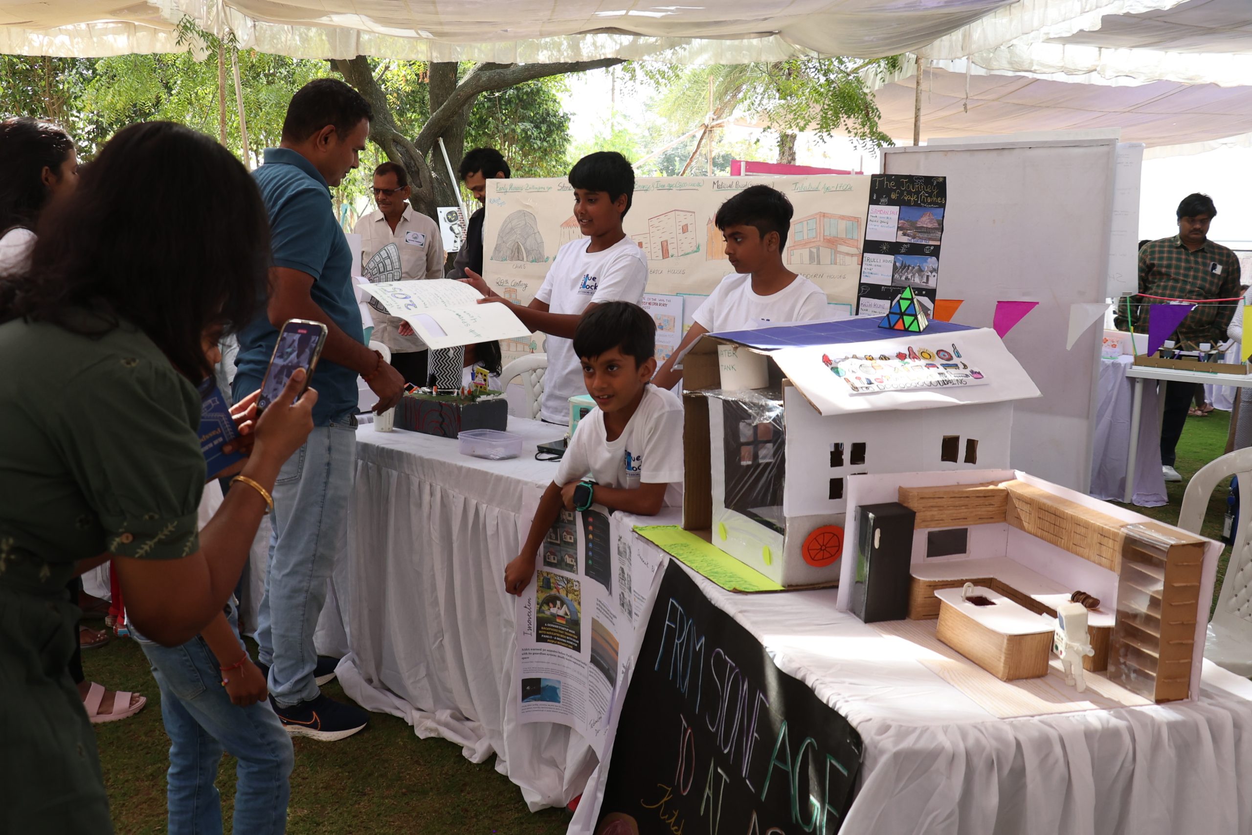 Children showcasing their own innovations prepared in a Montessori environment, how to prepare children for the future at EXPLORE Montessori annual event at Blue Blocks Montessori School, Hyderabad.