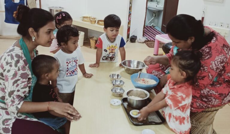 A child learning mealtime at a shared table with real materials at child height — how to create a positive mealtime environment at Blue Blocks Montessori School, Hyderabad