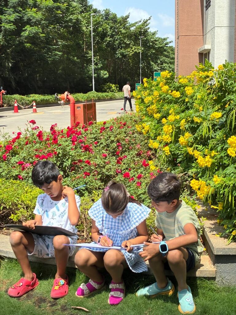 Young children caring and observing plants. How to keep children connected to nature through everyday home habits at Blue Blocks Montessori School, Hyderabad